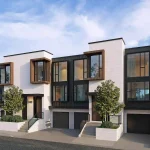 Exterior rendering of modern townhomes at Le Sentier Towns showcasing contemporary white masonry, dark cladding, and wood-toned window frames.