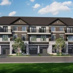 Exterior front view of modern multi-story townhomes at Lyric by Lynde Creek featuring dark brick, stone accents, black metal balconies, and integrated garages.