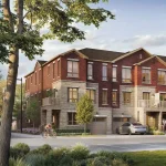 Modern three-story townhouse community at Walnut Creek in East Gwillimbury with red brick and light stone exteriors, private garages, upper-level balconies, and a cyclist riding on the street.