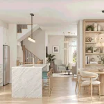Open-concept kitchen and dining room at Elements featuring a waterfall marble island, white cabinetry, stainless steel appliances, and a round wood dining table.