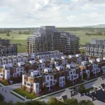 Aerial view of the entire Elements Milton master-planned community showcasing modern townhouses, mid-rise condo buildings, and surrounding green fields.
