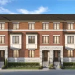 Exterior front elevation of modern three-story brick and stone townhomes with landscaped front entries at the Elements residential community.
