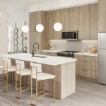 Modern open-concept kitchen interior rendering at Mackenzie Park featuring light wood cabinets, white waterfall island, and brass pendant light fixtures